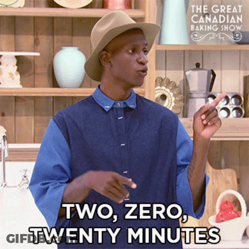 A Man Wearing A Hat And A Blue Shirt Is Standing In Front Of A Sign That Says The Great Canadian Baking Show GIF