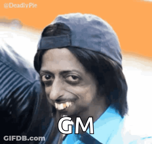 A Man Wearing A Hat And A Blue Shirt With The Word Gm On His Face GIF