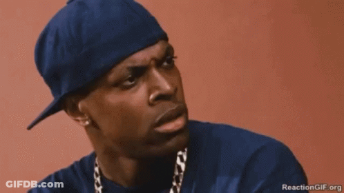 A Man Wearing A Hat And A Chain Is Making A Funny Face . GIF