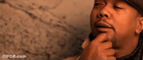 A Man Wearing A Hat And A Coat Is Thinking About Something GIF