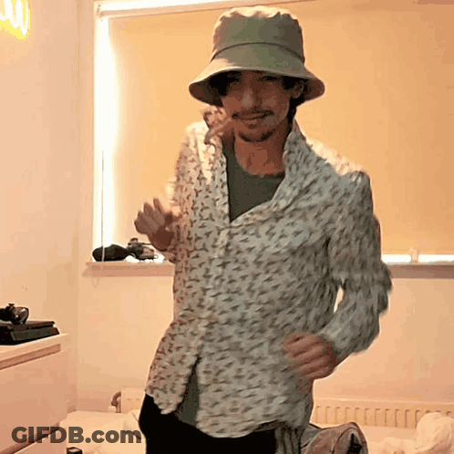 Man Dancing In Floral Shirt And Hat GIF