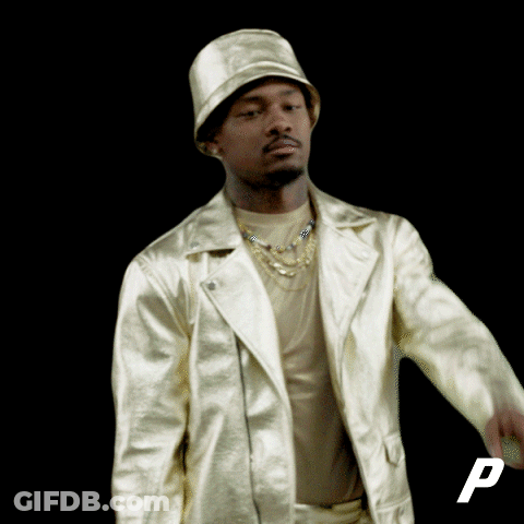 A Man Wearing A Hat And A Gold Jacket With The Letter P In The Corner GIF