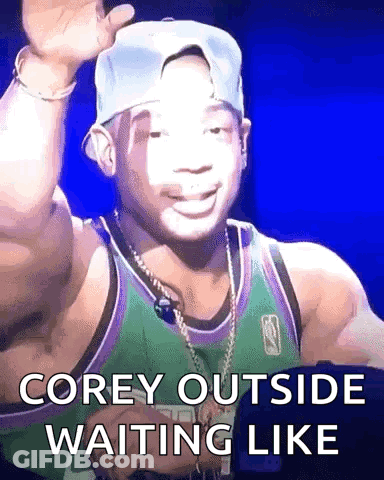 A Man Wearing A Hat And A Green Jersey Is Waiting Like Corey Outside GIF