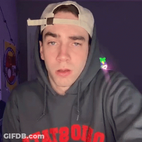 A Man Wearing A Hat And A Hoodie That Says Tat80 On It GIF