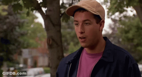 A Man Wearing A Hat And A Jacket Is Standing Under A Tree . GIF