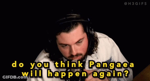 A Man Wearing A Hat And A Jacket Is Talking Into A Microphone GIF