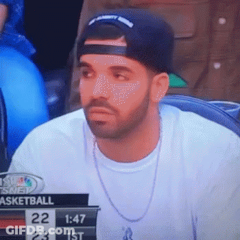 A Man Wearing A Hat And A Necklace Is Watching A Basketball Game On A Television . GIF