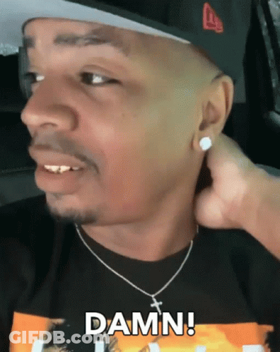 A Man Wearing A Hat And A Necklace Says Damn On His Face GIF