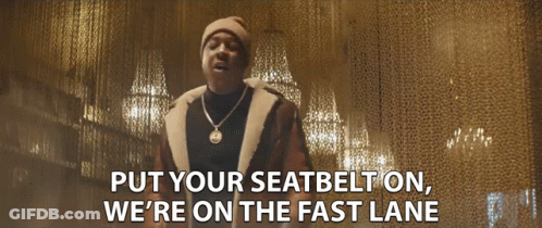 A Man Wearing A Hat And A Necklace Says Put Your Seatbelt On We 'Re On The Fast Lane GIF