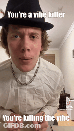 A Man Wearing A Hat And A Necklace Says You 'Re A Vibe Killer You 'Re Killing The Vibe GIF