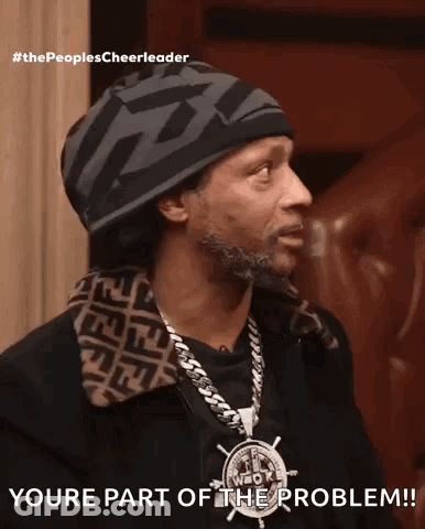 A Man Wearing A Hat And A Necklace Says Youre Part Of The Problem ! GIF