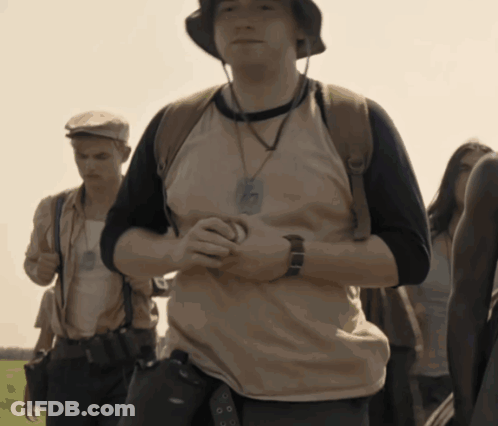 A Man Wearing A Hat And A Necklace With A Badge That Says ' Army ' On It GIF