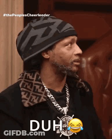 A Man Wearing A Hat And A Necklace With The Word Duh On It GIF