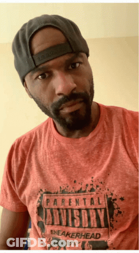 A Man Wearing A Hat And A Parental Advisory Sneakerhead Shirt GIF