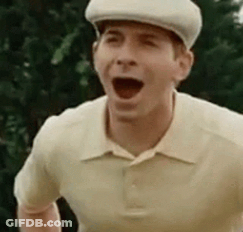 A Man Wearing A Hat And A Polo Shirt Is Making A Funny Face . GIF