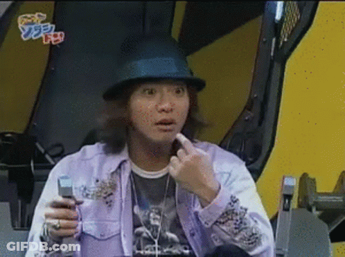A Man Wearing A Hat And A Purple Shirt Holds A Cell Phone In His Hand GIF