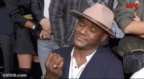 A Man Wearing A Hat And A Ring With Ufc Written On The Bottom Right GIF
