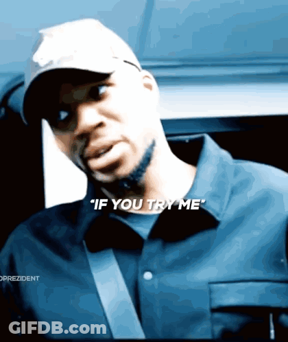 A Man Wearing A Hat And A Shirt Says " If You Try Me " GIF