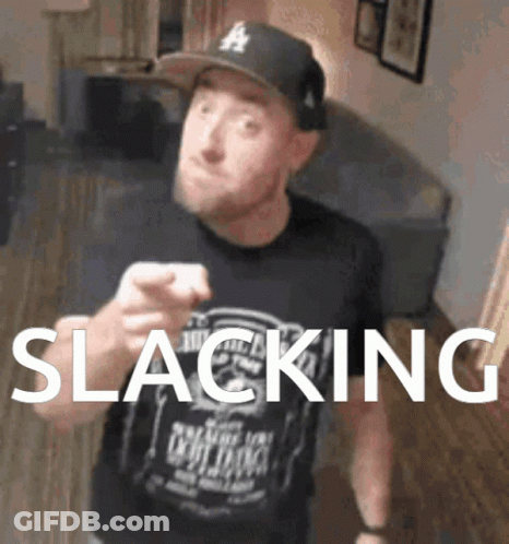A Man Wearing A Hat And A Shirt That Says Slacking Is Pointing At The Camera GIF