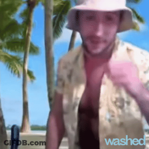 A Man Wearing A Hat And A Shirt That Says " Washed " GIF