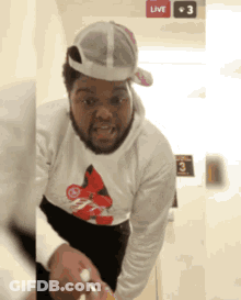 A Man Wearing A Hat And A Shirt With The Number 3 On The Bottom Right GIF