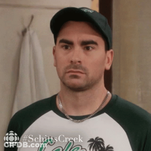A Man Wearing A Hat And A Shirt With The Word Schitts Creek On It GIF