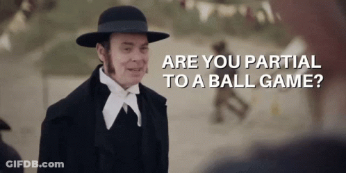 A Man Wearing A Hat And A Suit Says " Are You Partial To A Ball Game " GIF