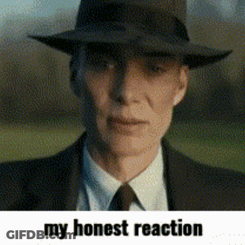 A Man Wearing A Hat And A Suit With The Words My Honest Reaction Below Him GIF