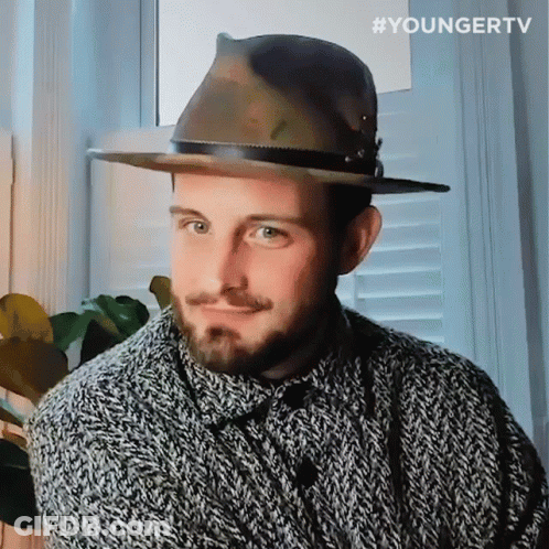 A Man Wearing A Hat And A Sweater With The Hashtag Youngertv On The Bottom Right GIF