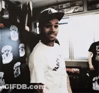 A Man Wearing A Hat And A T-Shirt That Says " Black " On It GIF