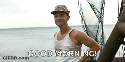 A Man Wearing A Hat And A Tank Top Is Standing On A Boat In The Ocean And Saying `` Good Morning '' . GIF