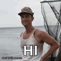A Man Wearing A Hat And A Tank Top Is Standing On A Boat In The Ocean . GIF