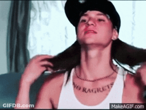 A Man Wearing A Hat And A Tank Top That Says No Regrets On His Chest GIF