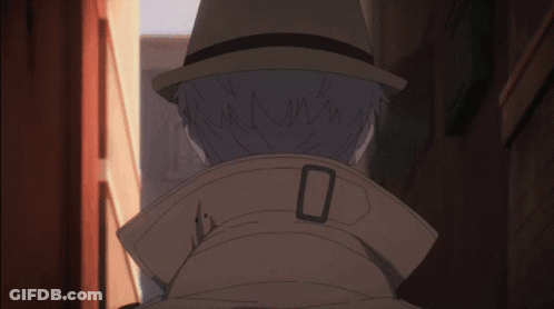 A Man Wearing A Hat And A Trench Coat Has The Number 0 On The Collar GIF