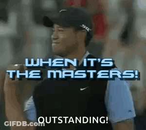 A Man Wearing A Hat And A Vest Is Standing In Front Of A Crowd And Holding A Microphone . GIF