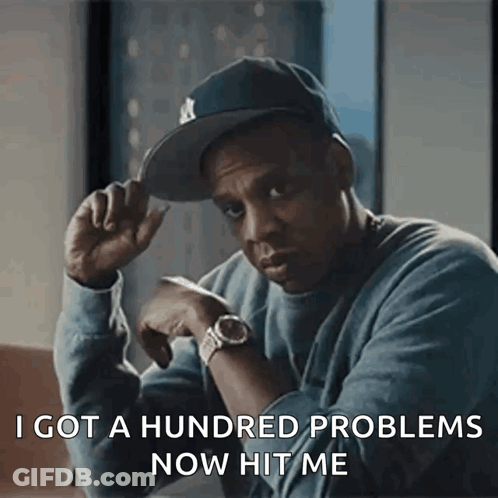A Man Wearing A Hat And A Watch Is Saying I Got A Hundred Problems Now Hit Me GIF