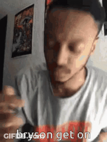 A Man Wearing A Hat And A White Shirt Is Eating A Hamburger And Says Bryson Get On . GIF