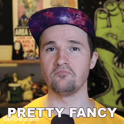 A Man Wearing A Hat And A Yellow Shirt With The Words Pretty Fancy Below Him GIF