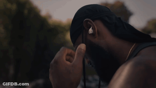 A Man Wearing A Hat And Ear Buds With The Letter O On It GIF