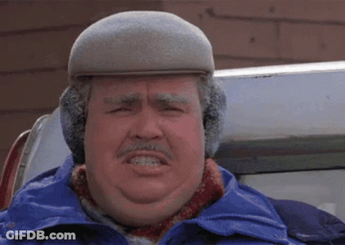 A Man Wearing A Hat And Ear Muffs Is Making A Face GIF