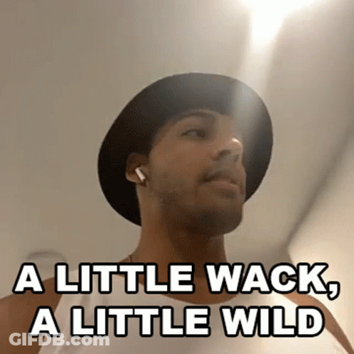 A Man Wearing A Hat And Earbuds Says A Little Wack A Little Wild GIF