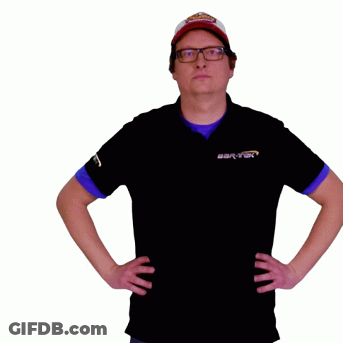 A Man Wearing A Hat And Glasses Holds A Cardboard Box In His Hand GIF