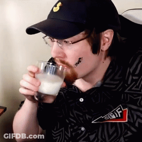 A Man Wearing A Hat And Glasses Is Drinking From A Glass . GIF