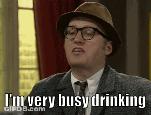 A Man Wearing A Hat And Glasses Is Saying I 'M Very Busy Drinking GIF