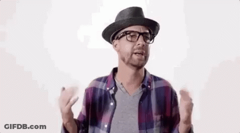 A Man Wearing A Hat And Glasses Is Talking To Someone . GIF