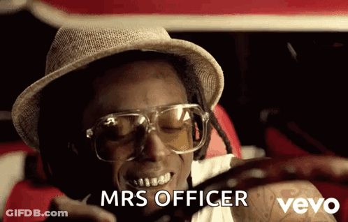 A Man Wearing A Hat And Glasses Says Mrs Officer On A Cell Phone GIF
