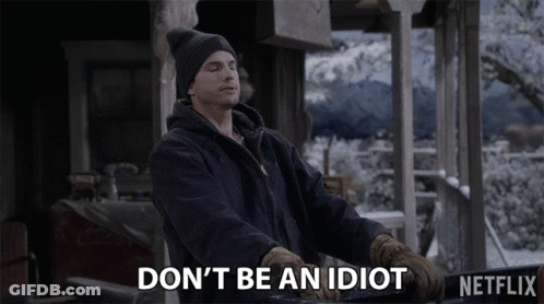 A Man Wearing A Hat And Gloves Says " Don 'T Be An Idiot " GIF