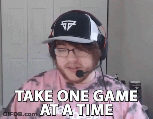 A Man Wearing A Hat And Headphones Is Saying Take One Game At A Time GIF