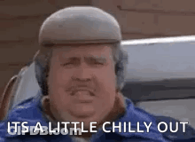 Man In Hat And Headphones Saying It's A Little Chilly Out GIF