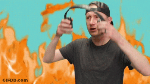 A Man Wearing A Hat And Headphones Is Standing In Front Of An Orange Background GIF